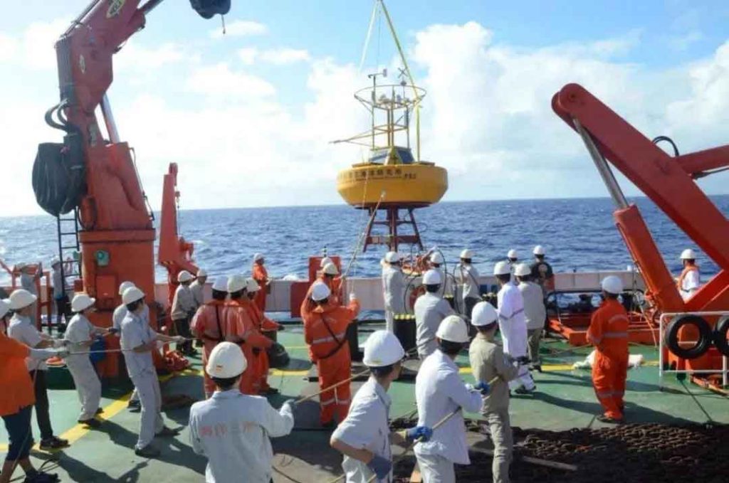 marine buoy lifted by crews