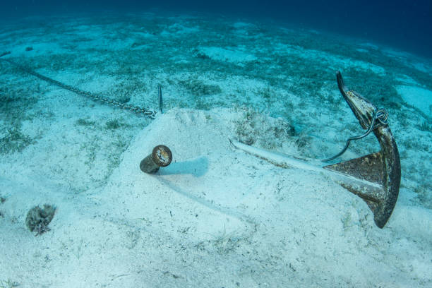 marine anchor resting on sandy seabed